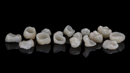 Excellent composition of ceramic dental crowns, removed on black glass