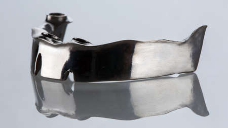 Perfect Titanium Dental Beam on White Glass With Reflectionの写真素材