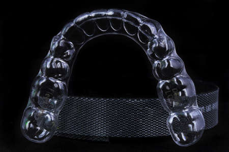 transparent aligner for teeth straightening on a black background
