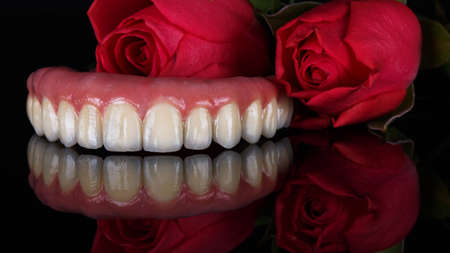 beautiful photo with flowers of metal ceramic dental prosthesis of the upper jaw