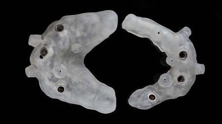Top view of two surgical dentals template for total implantation, photo on black background