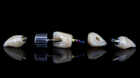 composition of high quality dental crowns on black glassの写真素材