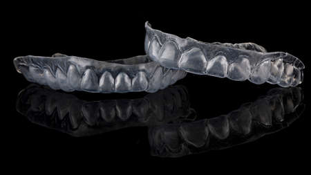 beautiful flexible dental capsule of the upper and lower jaw, shot on a black background with...