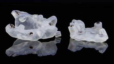 surgical dental templates for implantation of two jaws, on a black background