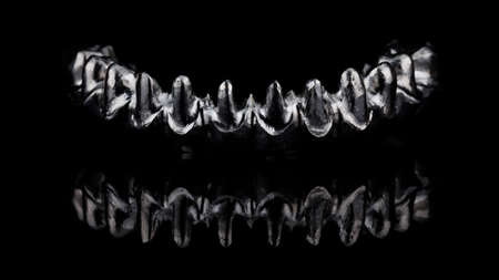 beautiful titanium bar for a permanent lower jaw prosthesis, filmed on a black mirror with creative...
