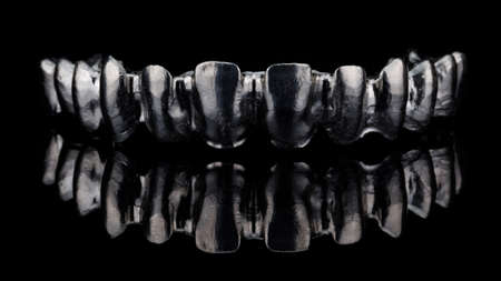 ideal titanium bar for creating a permanent upper jaw prosthesis, creative photography on black...