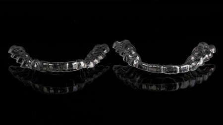 two dental individual mouthguards on a black backgroundの写真素材