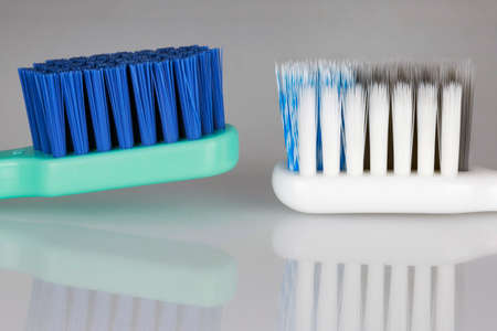 beautiful frame of two toothbrushes with reflection