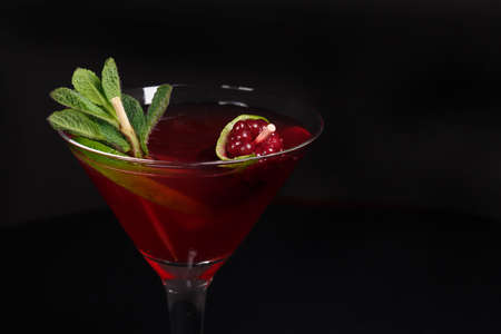 Daiquiri cocktail and beautifully decorated with mint leaves and fresh berries, shot with a large plan on a black backgroundの写真素材