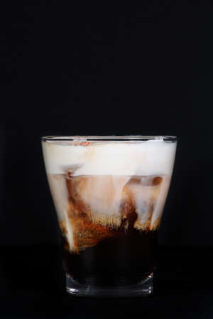 Cocktail home Lebovsky with a creamy taste, shot on a black background