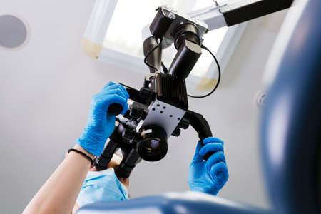 Dentist and modern microscope for complex tooth treatmentの写真素材