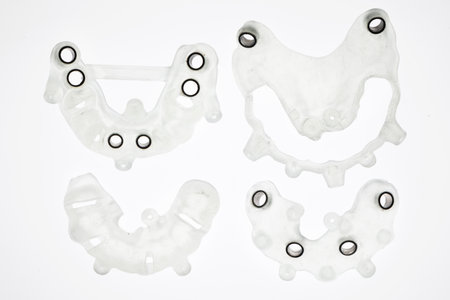 disassembled dental templates for total implantation, shot from above on a white background