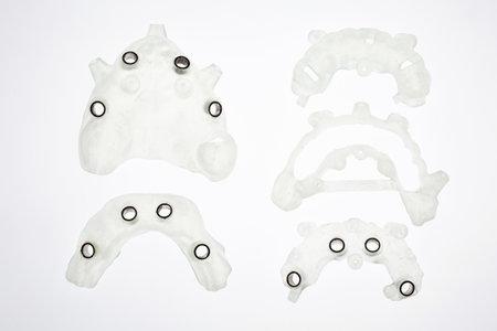 dental set of surgical templates for implantation of varying complexity on a white background