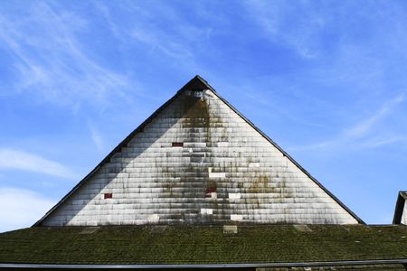 peak of a barn and blue sky