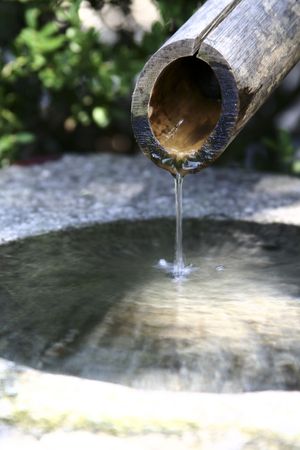 Dripping wooden water pipeの写真素材