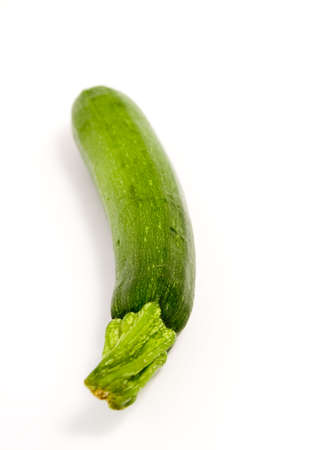 A fresh zucchini on a clean white backgroundの写真素材
