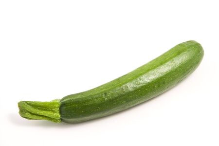 A fresh zucchini on a clean white backgroundの写真素材