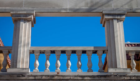 A Greek style balcony against a blue skyの写真素材