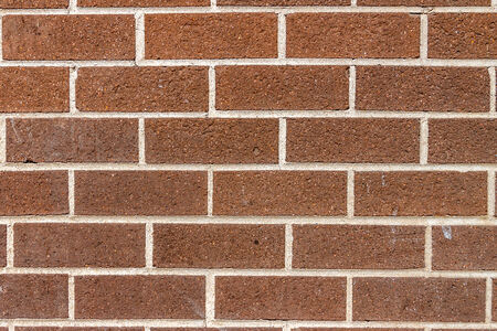 Red bricks with mortar in a wall