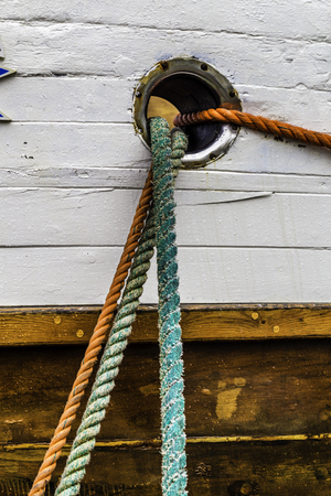 Ropes tying a ship to the dock in portの写真素材