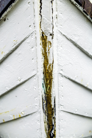Detail of an old white wooden boat hullの写真素材