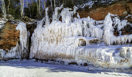 Ice covers the red cliffs along the Superior shore lineの写真素材