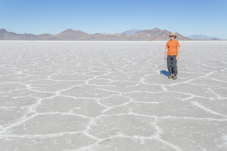 A tourist enjoying the Bonneville Salt Flats in Utahの写真素材