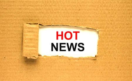 The text Hot News appearing behind torn brown paperの写真素材