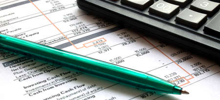 Financial Planning. Pen with a calculator on the background of tablesの写真素材
