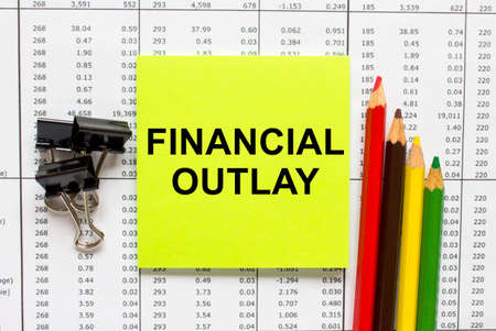 Text Financial Outlay on financial tables with pencils, glasses and paper clips. Business and financial conzeptの写真素材