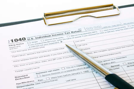 US tax form 1040 with a silver penの写真素材