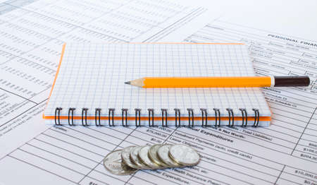 Financial concept. Coins with pencil on financial statementの写真素材