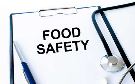 Text Food Safety on a sheet in the medical folder with a phonendoscope and penの写真素材
