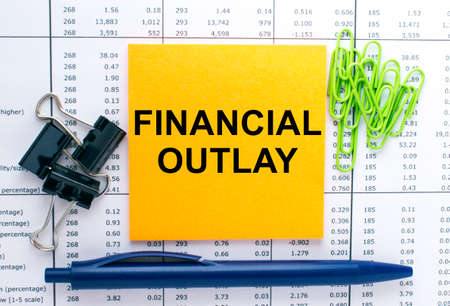 Text Financial Outlay on financial tables with pen and paper clips. Business and financial conzeptの写真素材