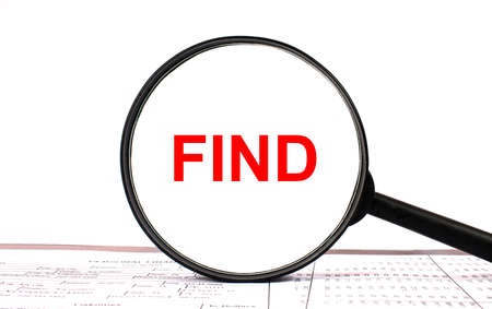 Magnifying glass with text Find on financial tablesの写真素材