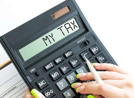 A calculator with text My Tax on the displayの写真素材