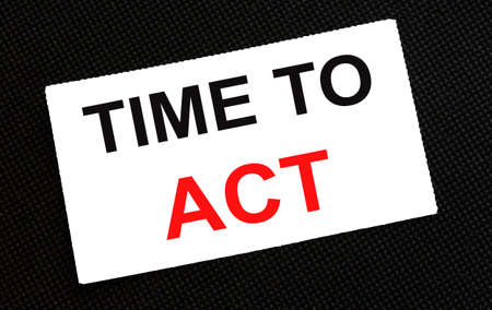 White card on the black background with text Time To Actの写真素材