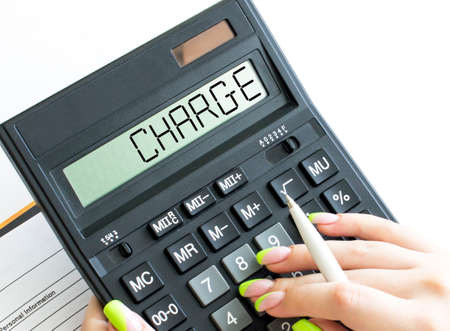 A calculator with text Charge on the displayの写真素材