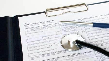 Prescription form lying on table with stethoscope and silver pen. Medicine or pharmacy concept.の写真素材