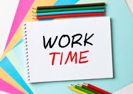 The Notepad with the text Work Time is on colored paper with color pencils. Concept photoの写真素材