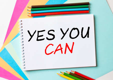 The Notepad with the text Yes You Can is on colored paper with color pencils. Concept photoの写真素材