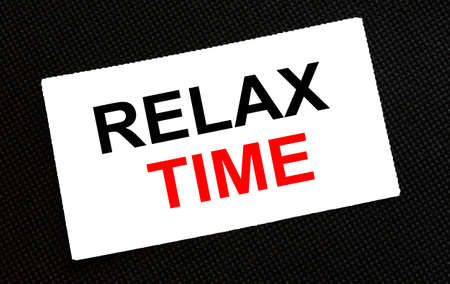 White card on the black background with text Relax Time. Concept photoの写真素材