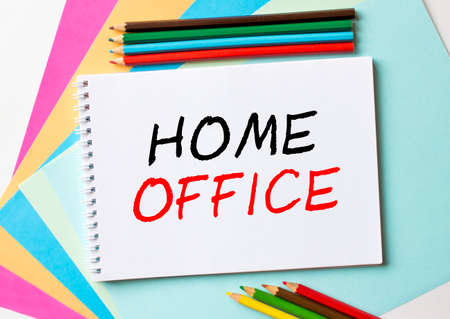 The Notepad with the text Home Office is on colored paper with color pencils. Concept photoの写真素材