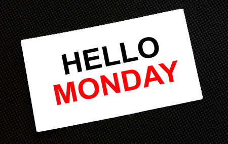 White card on the black background with text Hello Monday. Concept photoの写真素材