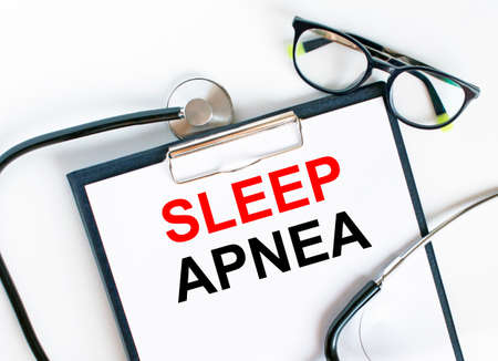Text Sleep Apnea in the folder with the stethoscope and glasses. Medical concept photoの写真素材