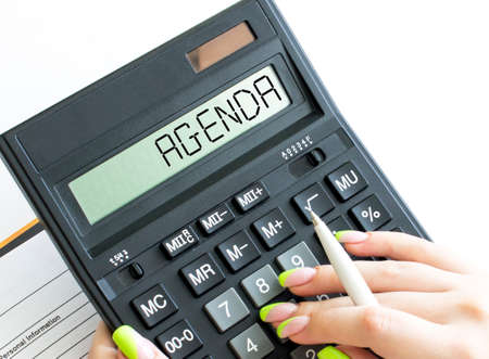 A calculator with text Agenda on the display. Business and financial conceptの写真素材