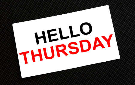 White card on the black background with text Hello Thursday. Concept photoの写真素材