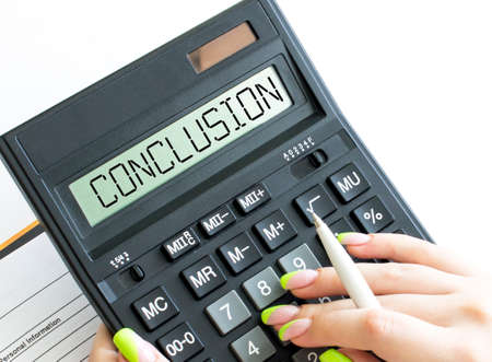 A calculator with text Conclusion on the display. Business and financial conceptの写真素材