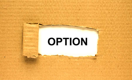 The word Option appearing behind torn brown paper. Can be use as a concept photoの写真素材