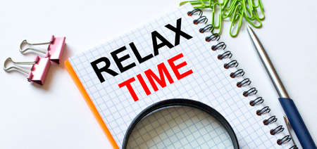 Notepad with text Relax Time on white background with clips, pen and magnifying glass. Can be use as concept photoの写真素材